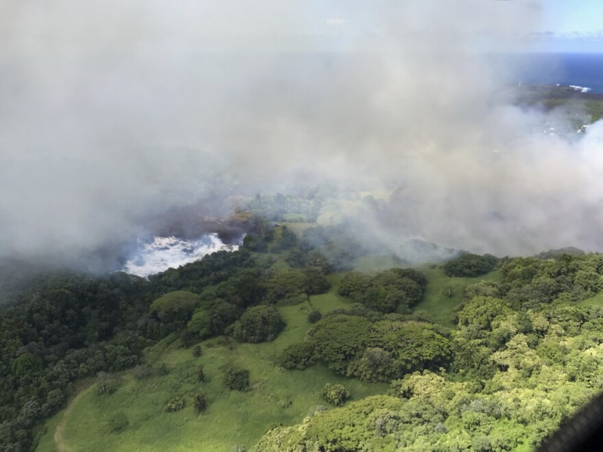 Lava steams after it hit Hawaii's Green Lake, which had been filled with water hours before, on Saturday.