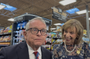 Gov Mike and First Lady Fran DeWine at a Columbus-area Kroger store on September 25, 2026. They were there to talk about the store's participation in the Dolly Parton Imaginary Library program on what DeWine has declared "Dolly Parton Day" in Ohio. Gov. DeWine also talked to reporters about a gas tax holiday bill being proposed by the Ohio Legislature.