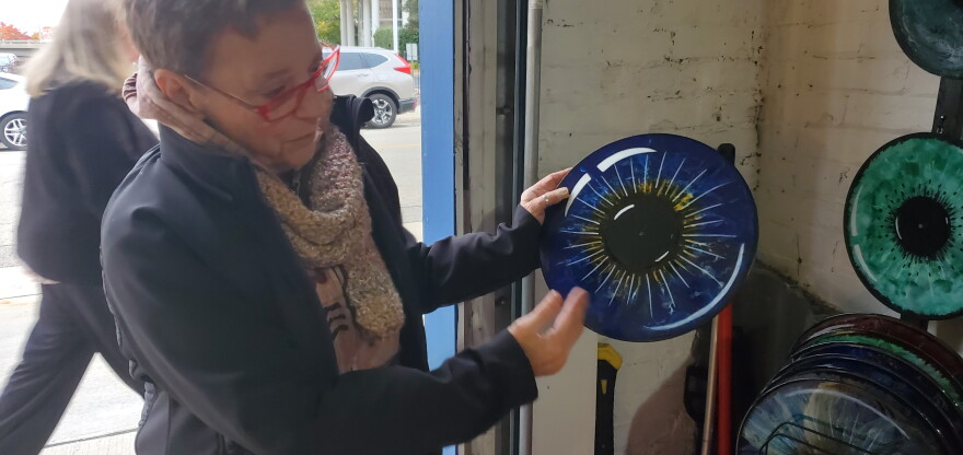 Chris McDermand showing off records that she transformed into art.