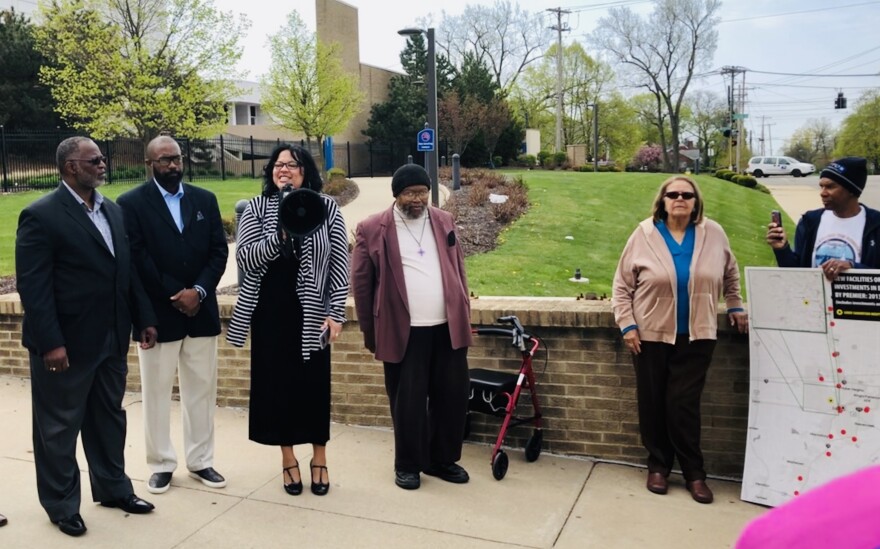 Father Benjamin Speare-Hardy (left), Rev. Rockney Carter, Rev. Merritt Worthen, and Bishop Richard E. Cox (fourth from the left); with the Clergy Community Coalition address a small gathering in front of the former Good Samaritan Hospital.