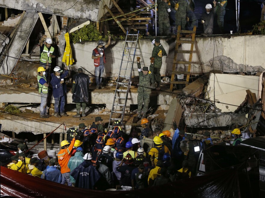 Rescue crews try to free a trapped child at the Enrique Rebsamen primary school in Mexico City on Wednesday after a powerful earthquake jolted central Mexico a day earlier.