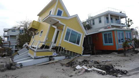 FILE - A house lies toppled off its stilts after the passage of Hurricane Milton, in Bradenton Beach on Anna Maria Island, Fla., Oct. 10, 2024.