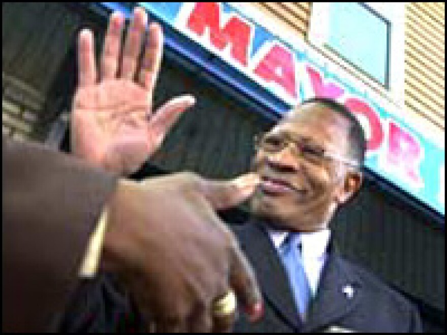 Sharpe James shaking hands with voters.