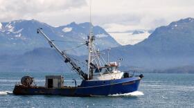 Gillnet boat in the ocean with mountains in the background