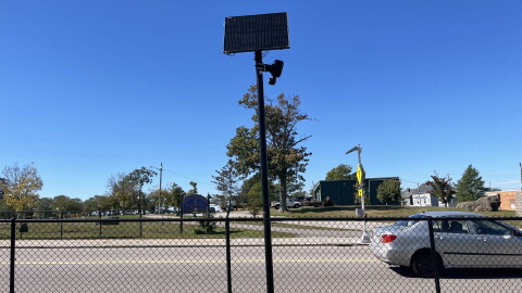 A Flock camera stands along the roadside near Kennedy Park as traffic passes by in Fall River, Mass., Tuesday, Oct. 6, 2026.