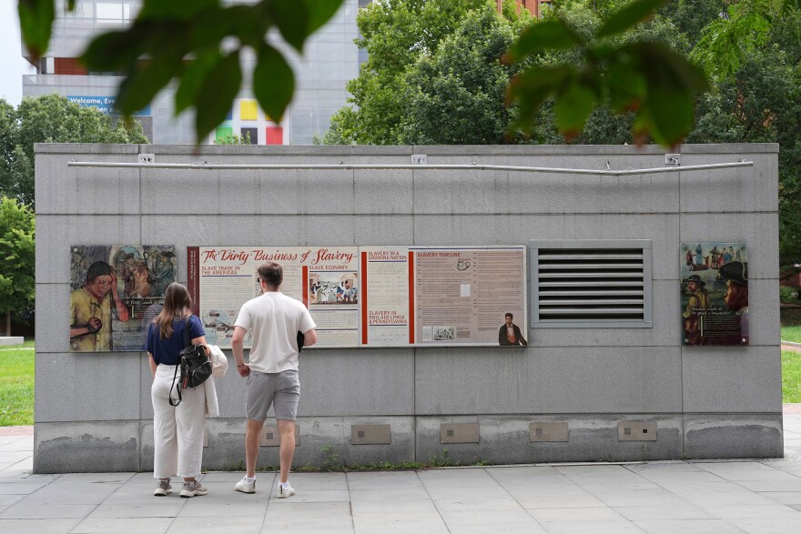FILE - People look an informational panel at President's House Site Tuesday, Aug. 19, 2025, in Philadelphia. 