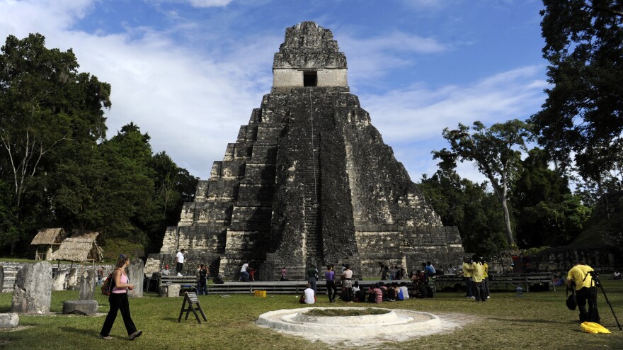 Tourists are seen in front of the "Gran Jaguar" Mayan temple at the Tikal archaeological site in Guatemala, where ceremonies will be held to celebrate the end of the Mayan cycle known as Baktun 13 and the start of the new Maya Era on December 21.