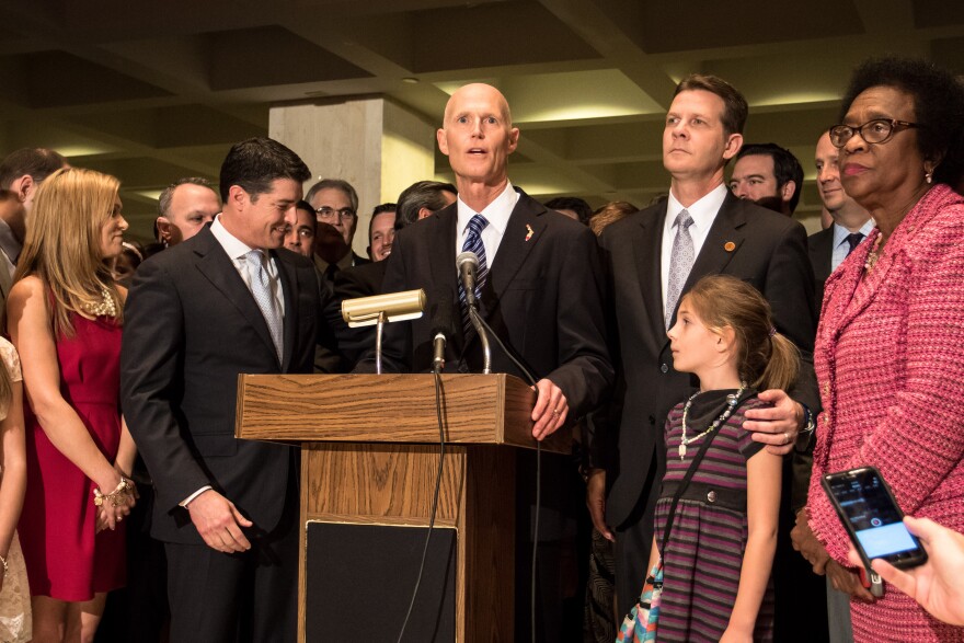 Governor Scott flanked by House Speaker Steve Crisafulli (left) Senate President Andy Gardiner (right) and Senate Minority Leader Arthenia Joyner (far right).