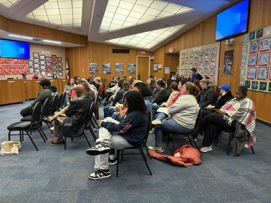 Alachua County public school teachers fill a meeting room on Tuesday as they wait to voice their opinions on the school board's salary proposal. (Alex Land/WUFT News)