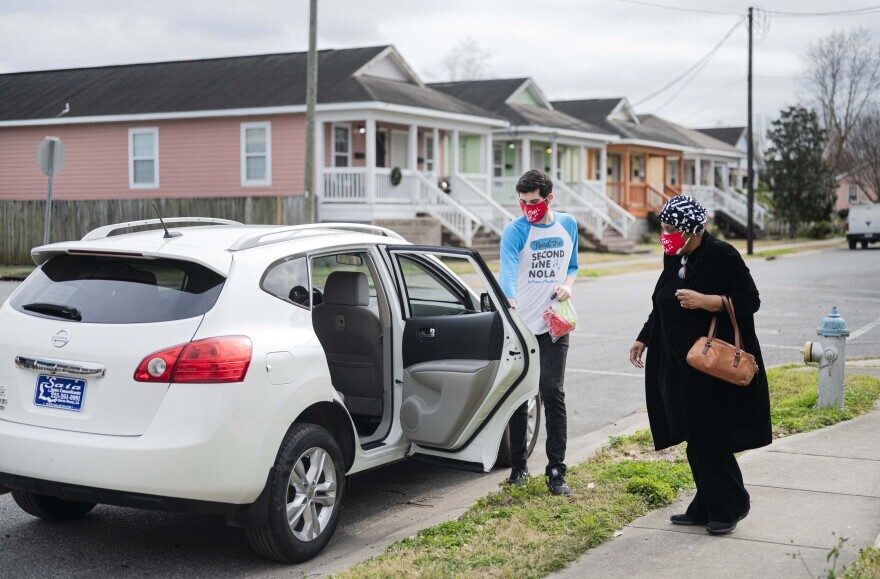 Cherice Harrison-Nelson, co-founder of the Mardi Gras Indians Hall of Fame and Big Queen of the Guardians of the Flame Mardi Gras Indians, is escorted by musician and Krewe of Red Beans (KRB) driver Nick Ellman, to get her COVID-19 vaccine.