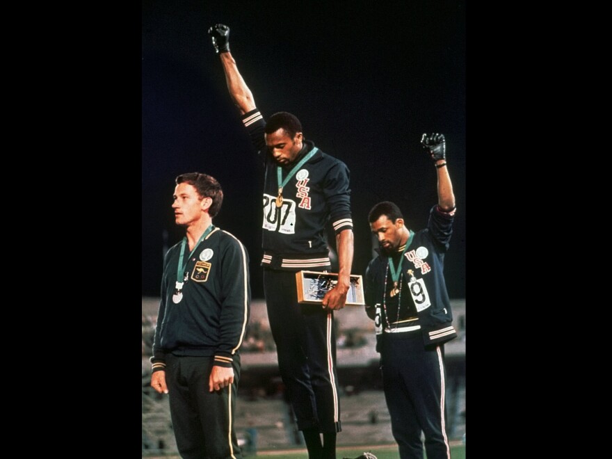 In a famous moment from the 1968 Summer Olympics in Mexico City, U.S. athletes Tommie Smith (center) and John Carlos raise their gloved fists after Smith received the gold medal and Carlos the bronze for the 200-meter run.