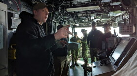 Senior Chief Quartermaster Martin Butte points out different areas of the bridge while the USS Iwo Jima was docked in Norfolk.