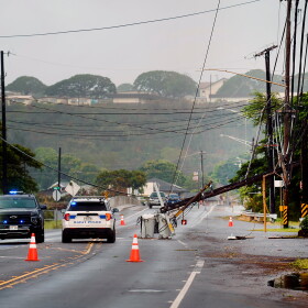 Downed power lines caused by Hurricane Lowell are seen across a road Tuesday, Sept. 8, 2026, in Hanapēpē, Kauaʻi, Hawaiʻi.