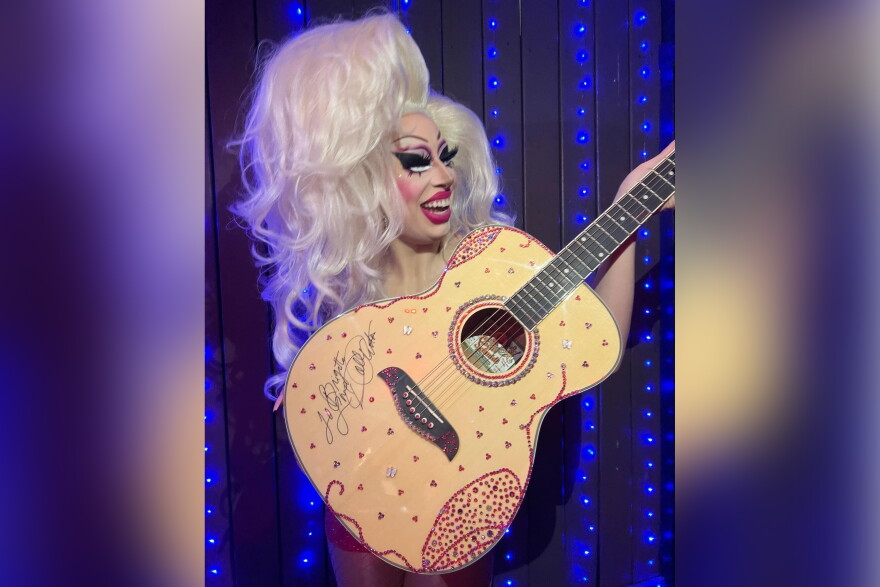 Dolly Parton gave Brigitte Bandit a custom rhinestoned guitar for her work fighting drag bans at the Texas Capitol in 2023.