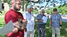 Tyler Meyers, Joe Granteed, Walter Griffith and Thomas Potsko prepare to hold a press conference.