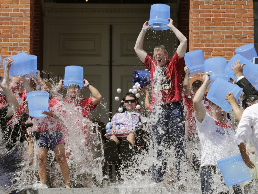 Pete Frates, (seated, center) participates in the Ice Bucket Challenge with Massachusetts Gov. Charlie Baker to raise money for ALS research at the Statehouse in Boston in 2015.