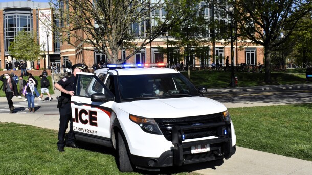 An Ohio State University Police officer gets into a patrol car at the Ohio Union.