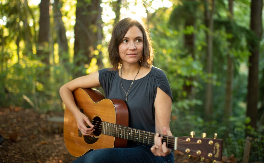 Jaspar Lepak playing guitar in the woods