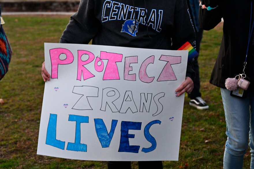 A CCSU student holding a handmade sign that says "Protect Trans Lives" right before the protest against the screening of the documentary "What is a Woman?" Created by Matt Walsh.