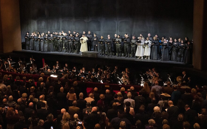 The Metropolitan Opera orchestra and chorus performing the Ukrainian national anthem before the opening night performance of Verdi's "Don Carlos."
