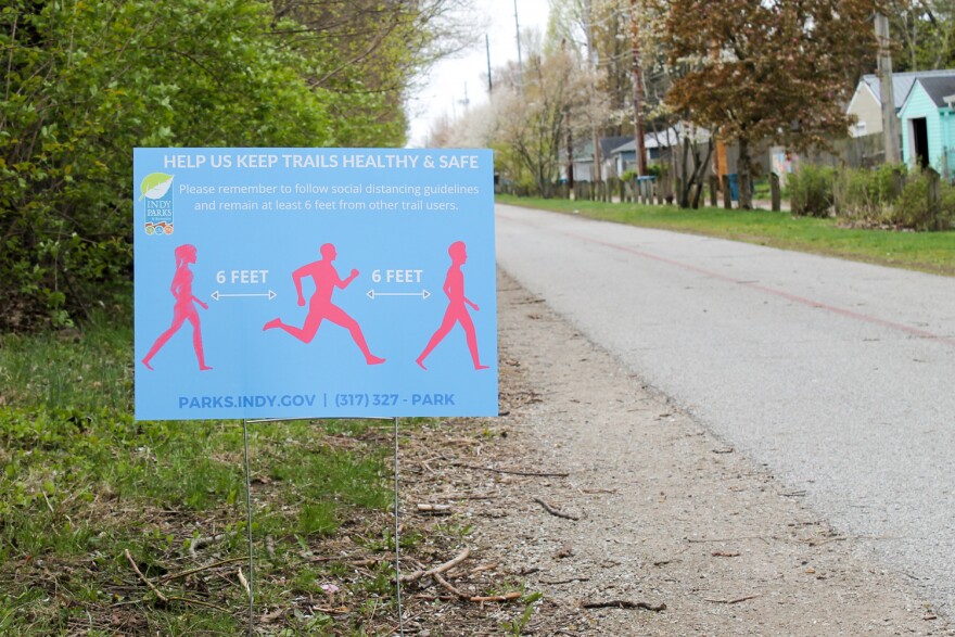 Along Indianapolis's Monon Trail, signs offer guidance on how to maintain social distancing from other trail users.