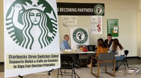 Richard Bensinger, left, who is advising unionization efforts, along with baristas Casey Moore, right, Brian Murray, second from left, and Jaz Brisack, second from right, discuss their efforts to unionize three Buffalo-area stores, inside the movements headquarters on Thursday, Oct. 28, 2021 in Buffalo, N.Y. (Carolyn Thompson/AP)