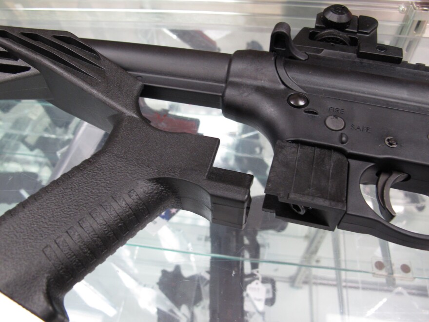 In this Feb. 1, 2013 file photo - taken at North Raleigh Guns in Raleigh, N.C. - a bump stock is placed near a disassembled .22-caliber rifle. Bump stocks will be banned in Vermont effective Oct. 1. People can voluntarily turn over bump stocks to the VSP.