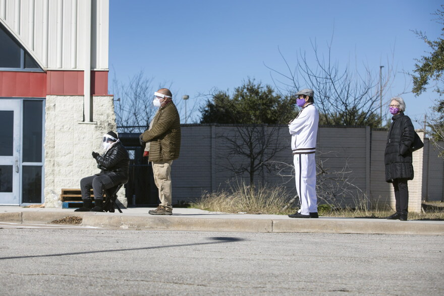 People in Austin wait in line for vaccinations at the Delco Activity Center. Some had appointments, while others did not, and there was confusion about whether those without appointments would be able to get vaccinated.