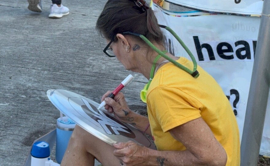 Stacey Snyder of North Fort Myers was painting a Wonder Woman shield at the protest in Fort Myers.