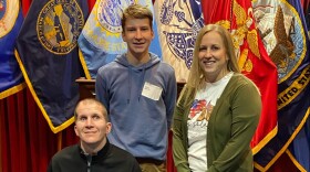 Sgt. Corey Briest (left) poses with his son Connor and wife Jenny, as Connor joins the South Dakota Army National Guard in Sioux Falls, March 11, 2022.