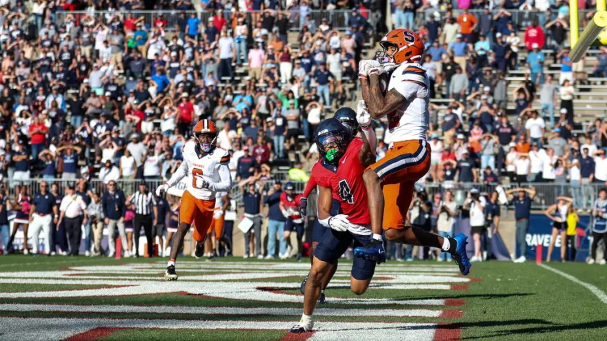 Umari Hatcher (2, White) receives a touchdown from quarterback Amari Odom against Connecticut.