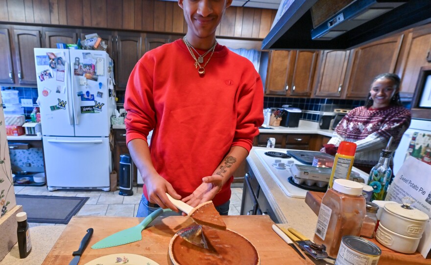 Aidan McFarlane slices sweet potato pie as his sister, Lydia, looks on.
