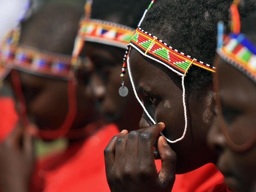 Some societies have come up with alternative rite-of-passage rituals to replace female genital mutilation. Above: A Massai teenager in Kenya attends such a ceremony.