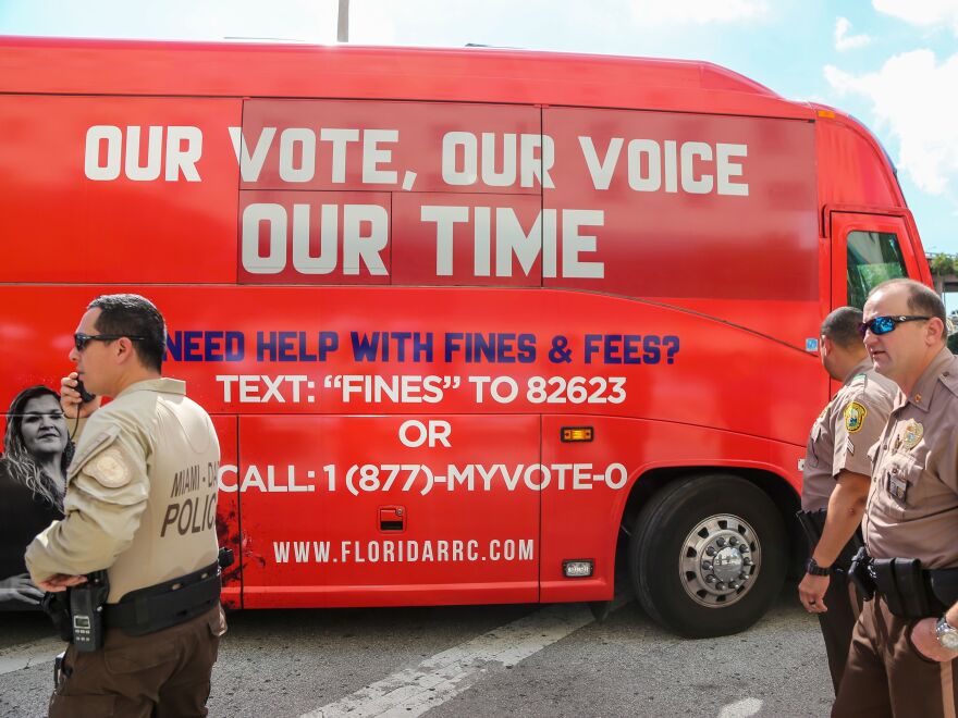 A tour bus, sponsored by the Florida Rights Restoration Coalition, pulls up to a Miami-Dade County courthouse ahead of a hearing aimed at restoring the right to vote under Florida's Amendment 4 on Nov. 8, 2019.