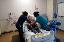 Two nurses help move a patient at Sentara Albemarle Medical Center.