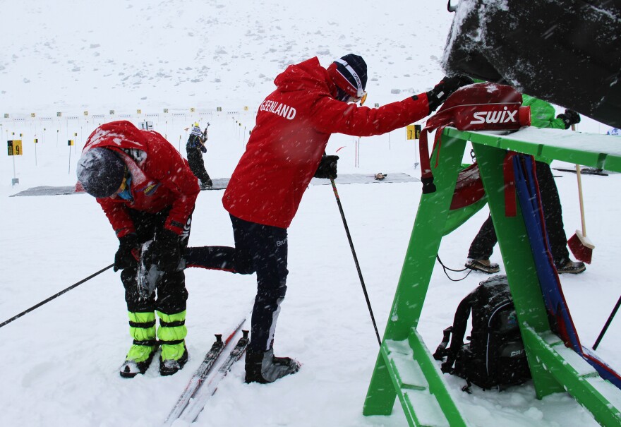 Greenlandic biathlon competitor Ukaleq Slettemark, 14, gets help cleaning her ski bindings from Uiloq Slettemark, her mother and coach,pre-race at the Arctic Winter Games. Ukaleq won in her age group.