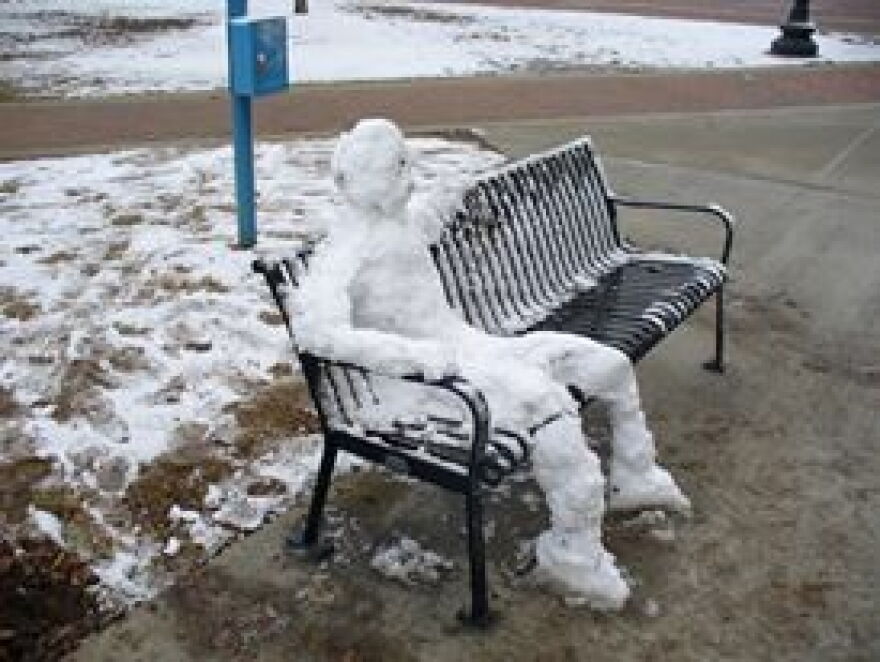 University of Alabama students build a snowman on a bench outside of Bryant-Denny stadium
