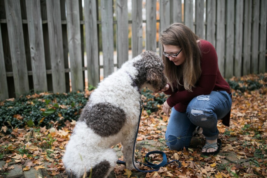 Jessica Moye spends time with Hachi in her yard outside Columbus, Ohio, on Oct. 30. Moye helps run a Facebook group dedicated to complaints about the company Diabetic Alert Dogs of America.