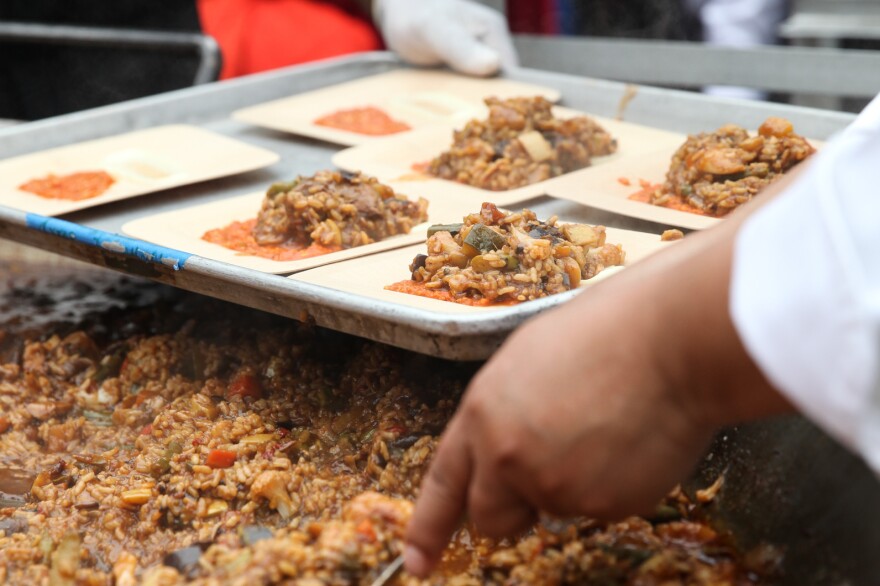 Volunteers prepare to hand out plates of paella made by celebrity chef José Andrés and his team.