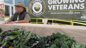 A veteran who goes by Cheech One-Road works Growing Veterans farm stand at the VA Hospital in Seattle.