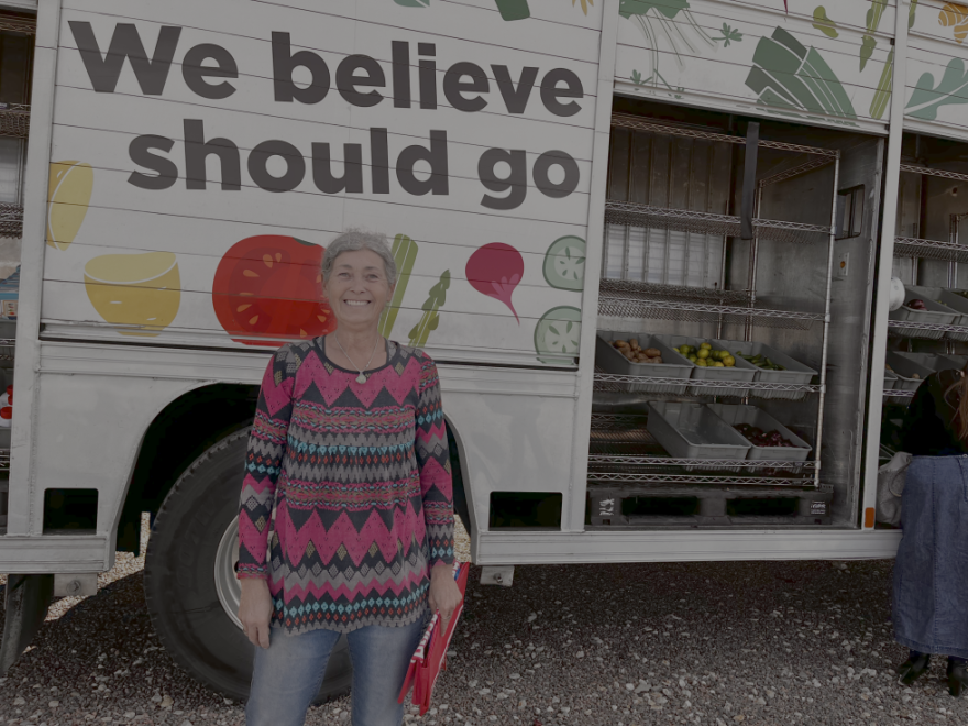 Rebecca Cardinell stands in front of The Mobile Market after she loads her and her sister's vehicles to distribute food to those unable to leave their homes.