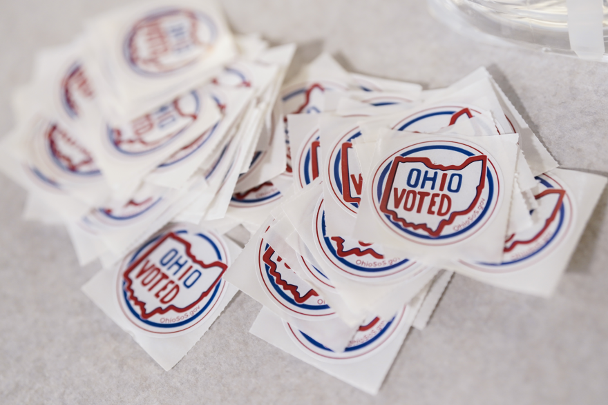 Stickers sit on a table inside a polling location on Election Day, Tuesday, Nov. 7, 2023, in Cincinnati.