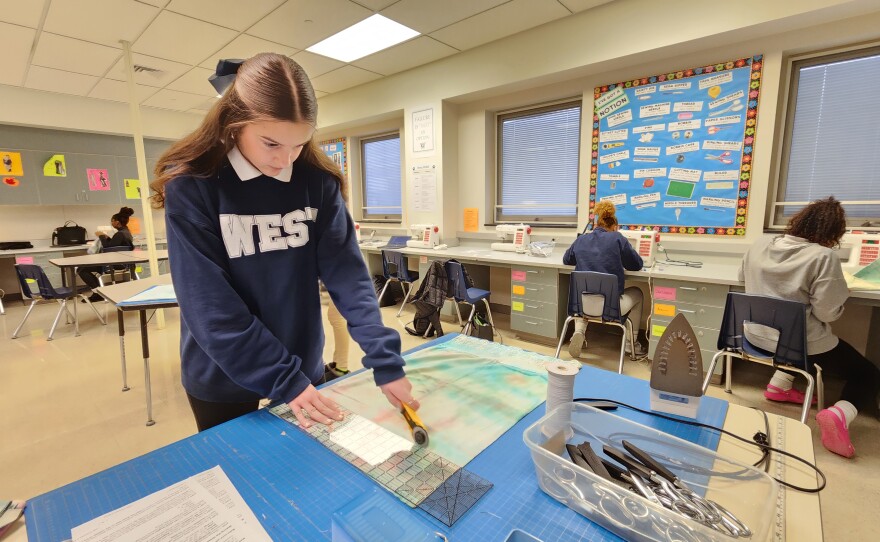 Freshman Angelina Sauerwein works on a dress that will be sent to Africa.