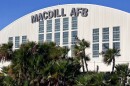 Airport hangar with the words MacDill AFB at the top. Palm trees are in front of the building. 