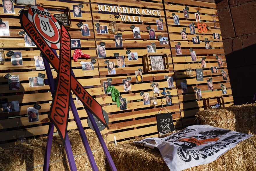 Pictures of those that died at Route 91 are seen on a wall at the Las Vegas Clark County Government Center.