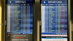 A screen shows Southwest Airlines arrivals on time to Kansas City, but more than half of the departures Canceled 