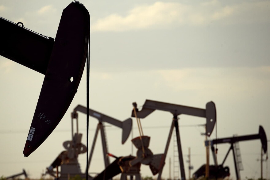 In this April 24, 2015 file photo, pump jacks work in a field near Lovington, N.M. (Charlie Riedel, File/AP)