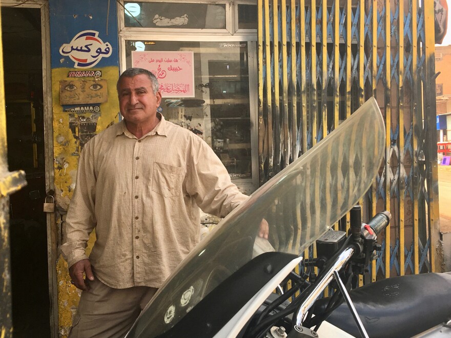 Qathem Sherif al-Jabouri at his motorcycle repair shop in Baghdad. Even though the former powerlifter spent 11 years in prison when Iraq was ruled by Saddam Hussein, he now says the country was better off in those days.