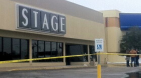 With the parking lot blocked-off, workers survey the damage at the Broken Arrow Stage store.