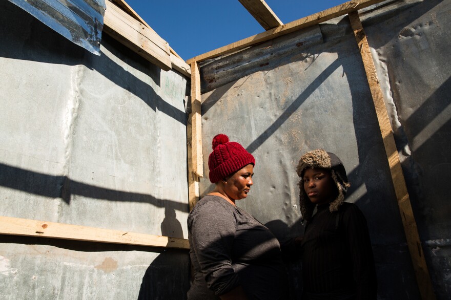 Noluthanda Gwanya and her daughter Inathi Sigijimi, 12. A storm the night before flooded their shack and blew off the roof, and they had to shelter with friends. "I don't want promises anymore. Just take us to the right place. We're hungry in the head and in the stomach," said Gwanya.